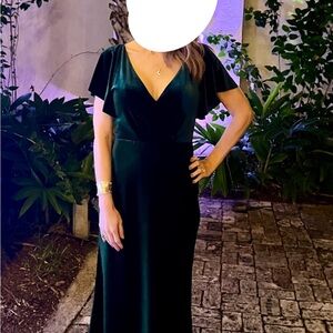 Formal dark green backless flutter sleeve dress.